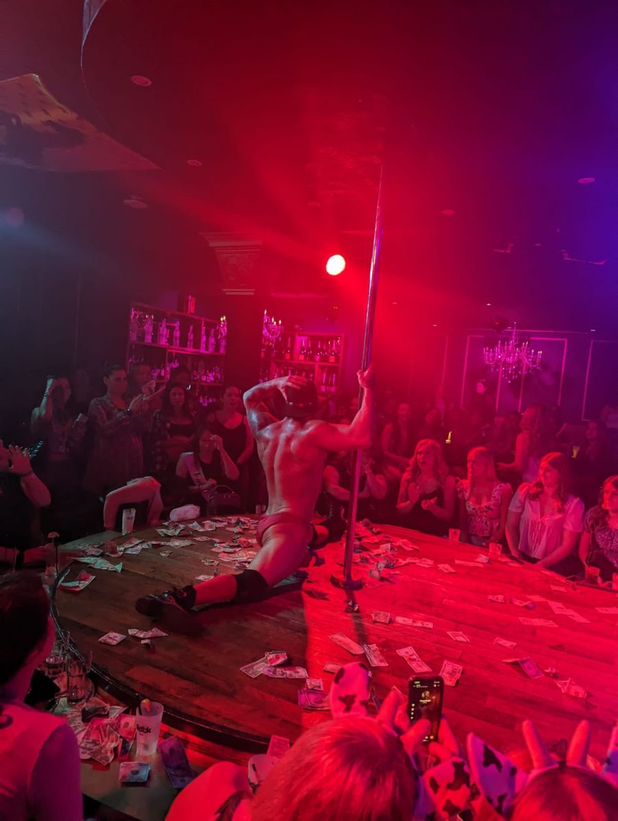 Male entertainer performing on stage under red lights