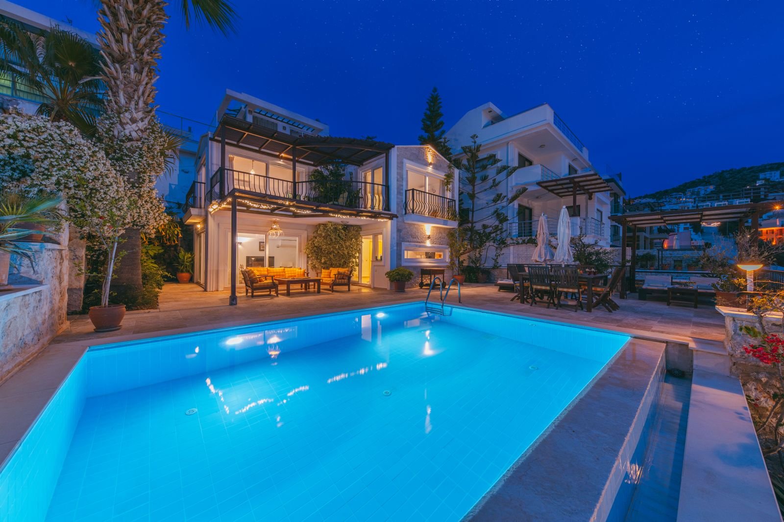 Private house with a lit pool at night