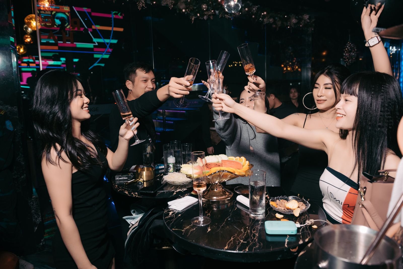 Friends toasting with bottle service on a VIP night out